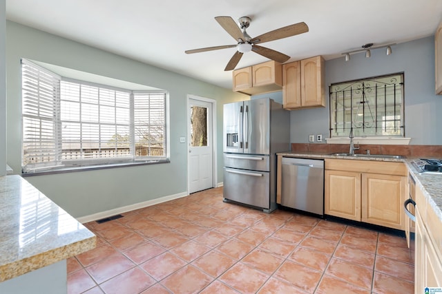 kitchen with visible vents, light brown cabinets, light tile patterned flooring, stainless steel appliances, and a sink