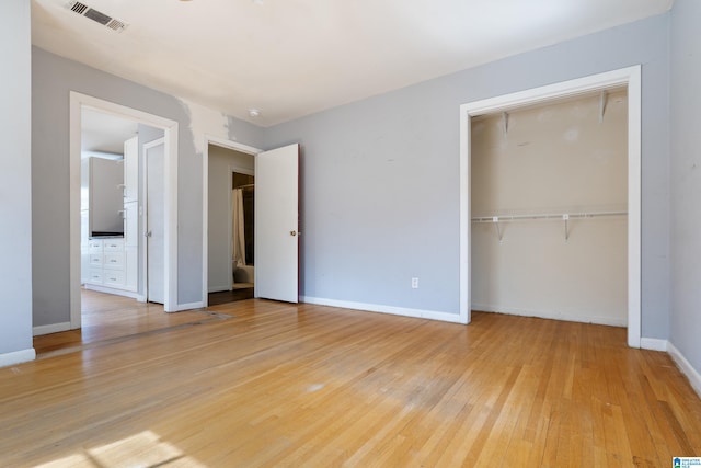 unfurnished bedroom with visible vents, baseboards, a closet, and light wood finished floors