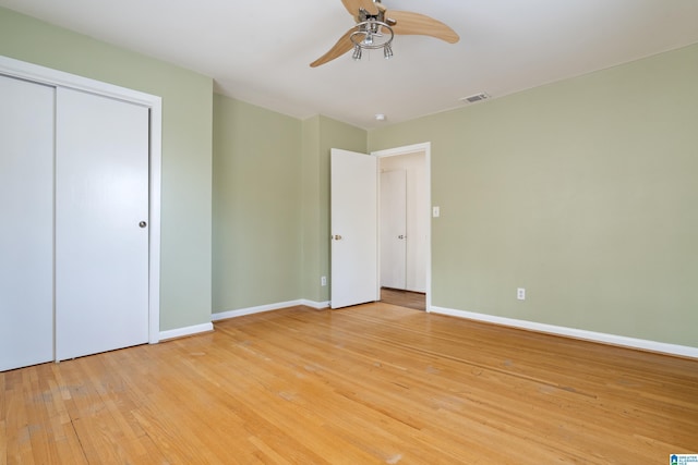 unfurnished bedroom with visible vents, baseboards, ceiling fan, light wood-style flooring, and a closet