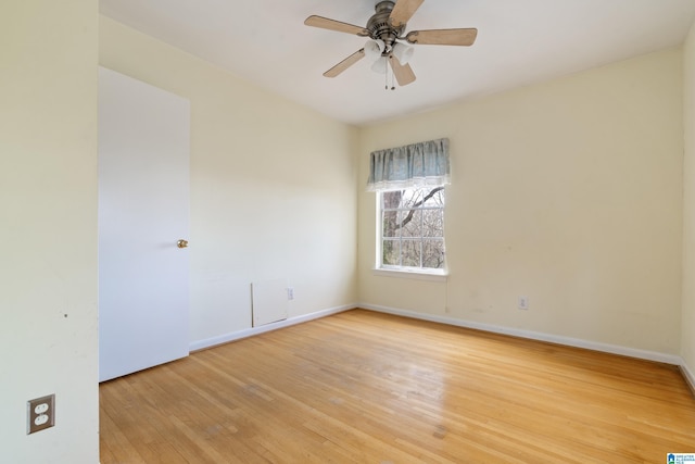 unfurnished room featuring baseboards, light wood-style floors, and a ceiling fan