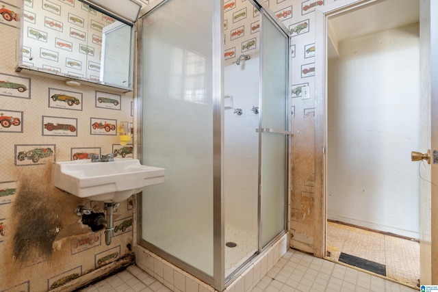 full bathroom with a sink, a stall shower, and wallpapered walls