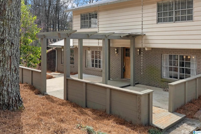 exterior space with covered porch and brick siding