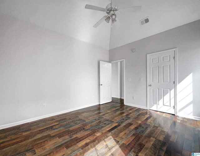 empty room featuring visible vents, high vaulted ceiling, a ceiling fan, dark wood finished floors, and baseboards