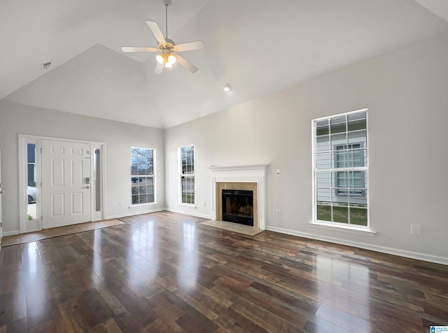 unfurnished living room featuring a ceiling fan, a fireplace with flush hearth, wood finished floors, and baseboards