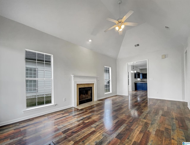 unfurnished living room with visible vents, high vaulted ceiling, hardwood / wood-style floors, a premium fireplace, and ceiling fan