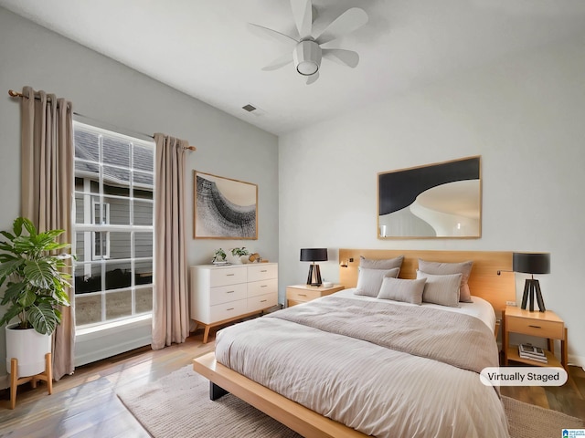 bedroom featuring visible vents, light wood-style flooring, and a ceiling fan