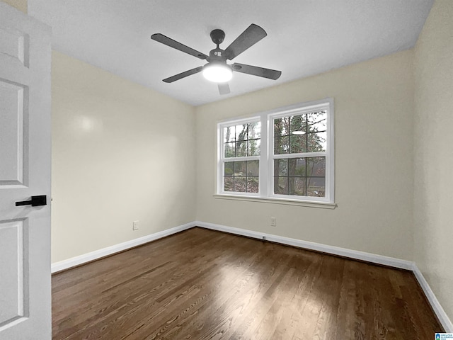 empty room featuring ceiling fan, baseboards, and wood finished floors