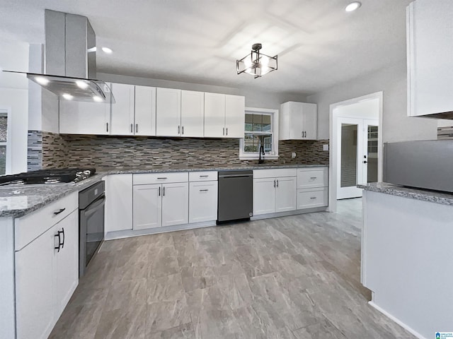 kitchen with black oven, dishwasher, island exhaust hood, stainless steel gas stovetop, and a sink