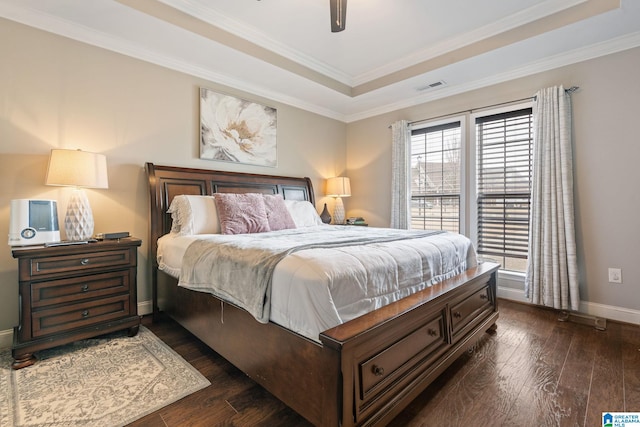 bedroom featuring visible vents, dark wood-type flooring, baseboards, and ornamental molding