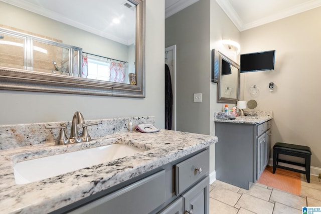 bathroom with tile patterned flooring, visible vents, crown molding, two vanities, and a sink