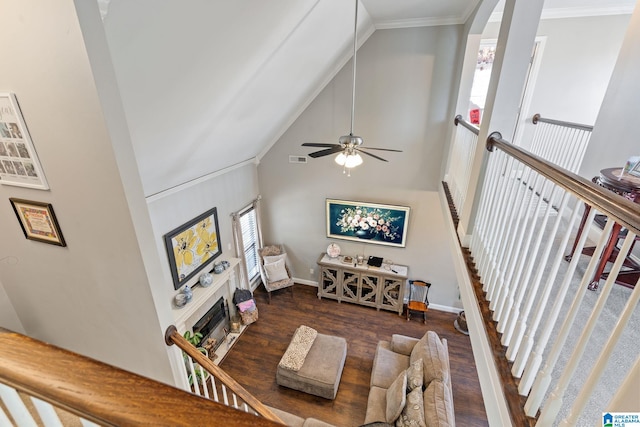 living room featuring visible vents, a fireplace, high vaulted ceiling, and wood finished floors