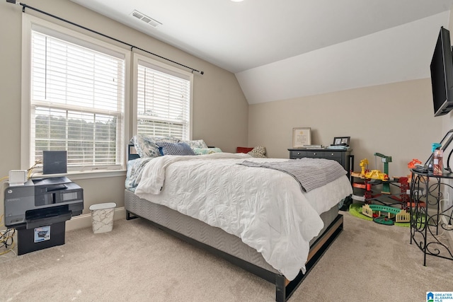 bedroom featuring visible vents, carpet floors, baseboards, and vaulted ceiling