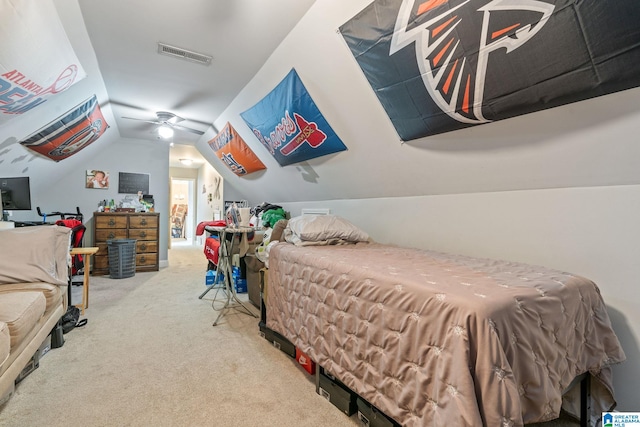 carpeted bedroom featuring visible vents, lofted ceiling, and a ceiling fan