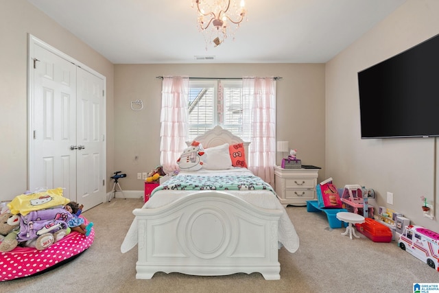 carpeted bedroom featuring a notable chandelier, visible vents, baseboards, and a closet