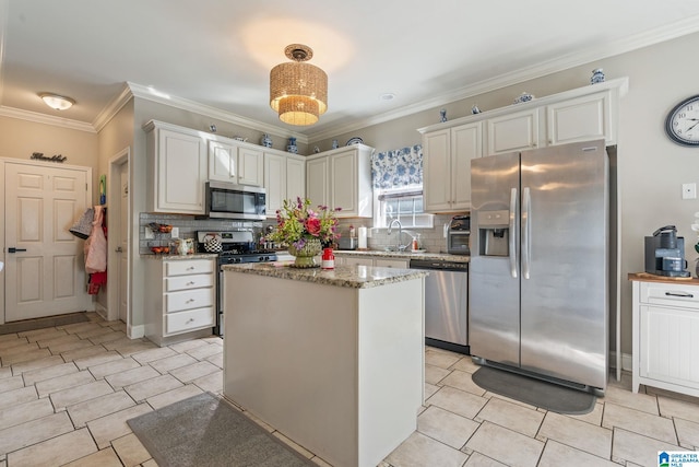 kitchen featuring ornamental molding, light tile patterned flooring, appliances with stainless steel finishes, and a sink