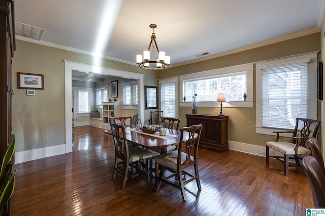 dining room featuring dark wood finished floors, baseboards, visible vents, and ornamental molding