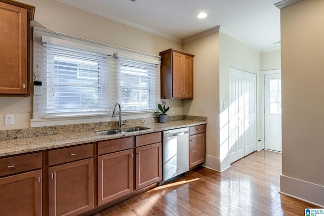 kitchen with stainless steel dishwasher, ornamental molding, plenty of natural light, and a sink