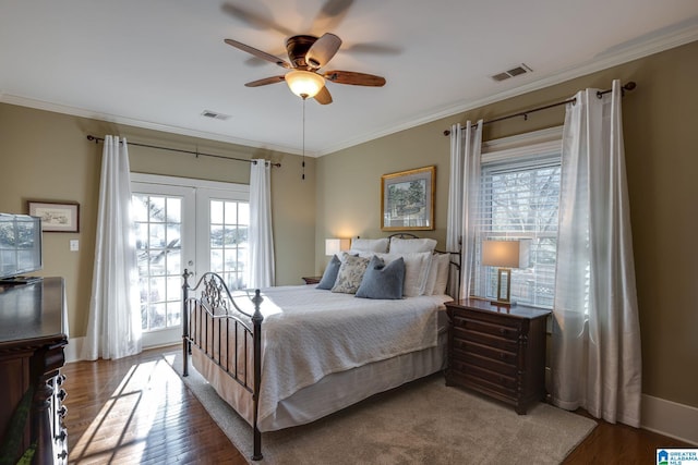 bedroom with visible vents, wood finished floors, crown molding, and french doors