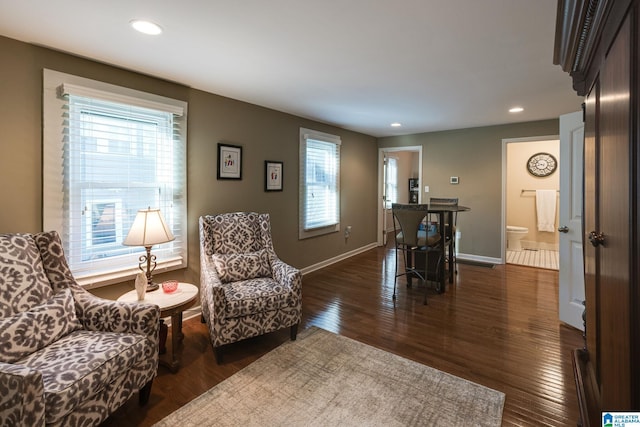 living area with recessed lighting, baseboards, and dark wood-style flooring