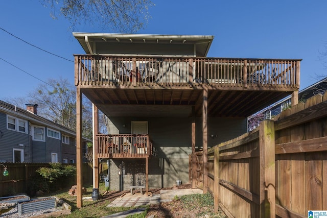 back of house featuring fence and brick siding