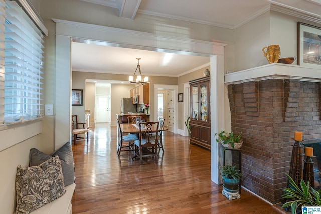 dining room featuring a notable chandelier, wood finished floors, and ornamental molding