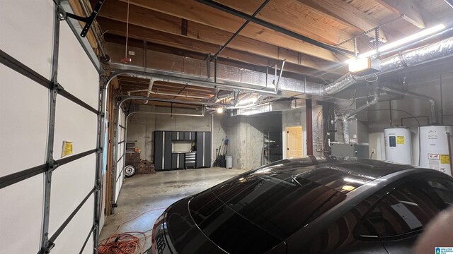 305 Camp Forrest Trl, Helena, AL 35080 - garage featuring electric water heater, water heater, heating unit, and a garage door opener