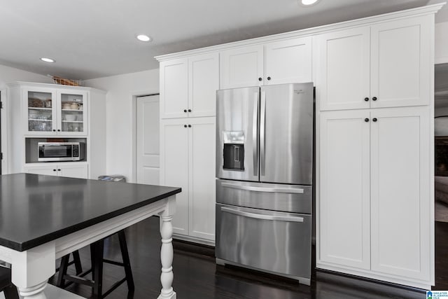 kitchen featuring dark wood-style floors, white cabinetry, recessed lighting, stainless steel appliances, and glass insert cabinets