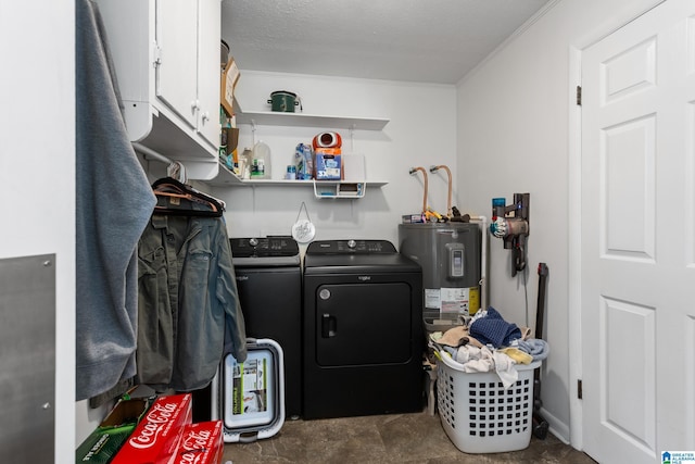 washroom featuring ornamental molding, a textured ceiling, electric water heater, cabinet space, and washing machine and clothes dryer