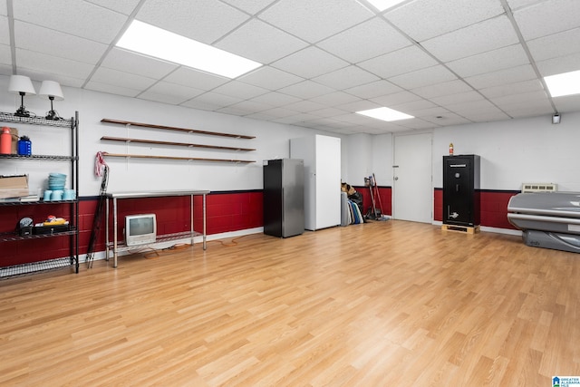 miscellaneous room with a drop ceiling and wood finished floors