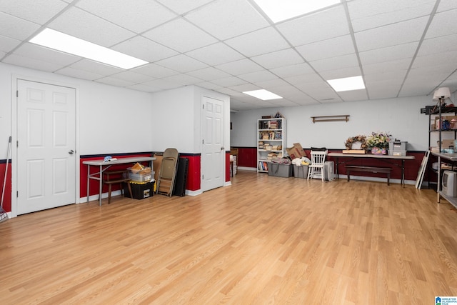 miscellaneous room with wood finished floors and a drop ceiling