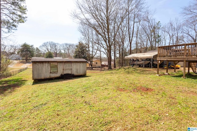 view of yard featuring an outbuilding, stairway, a deck, and fence