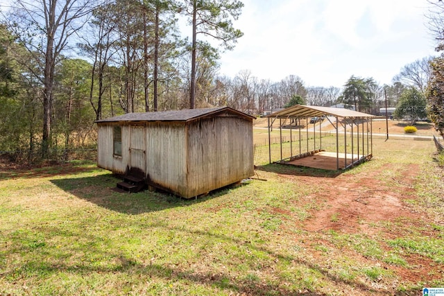 view of yard with an outbuilding, a carport, fence, and a shed