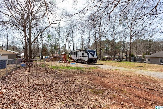 view of yard featuring fence and a playground