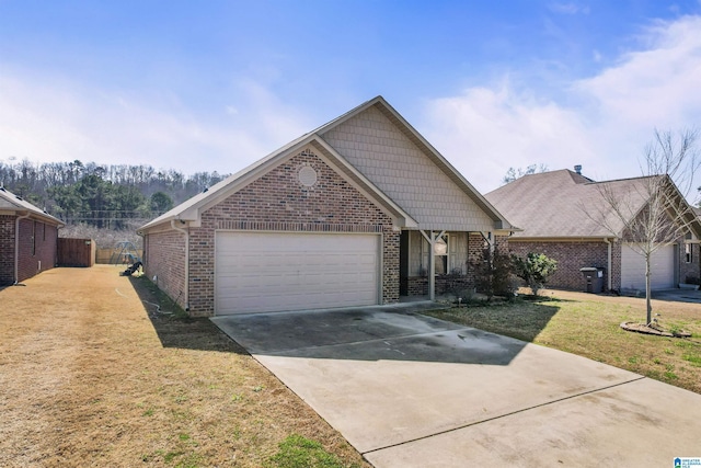 view of front of property with driveway, brick siding, an attached garage, and a front lawn