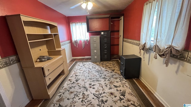 walk in closet featuring ceiling fan and wood finished floors