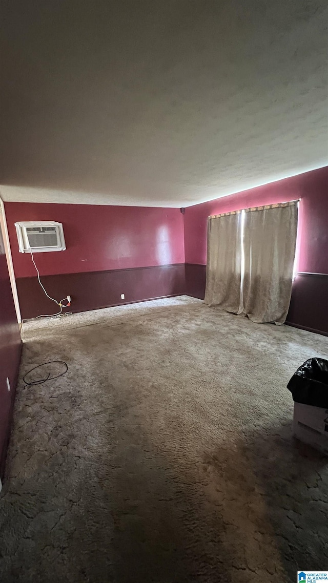 carpeted empty room with a wall mounted AC