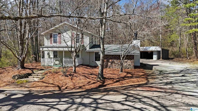 view of front of property featuring stone siding and a porch