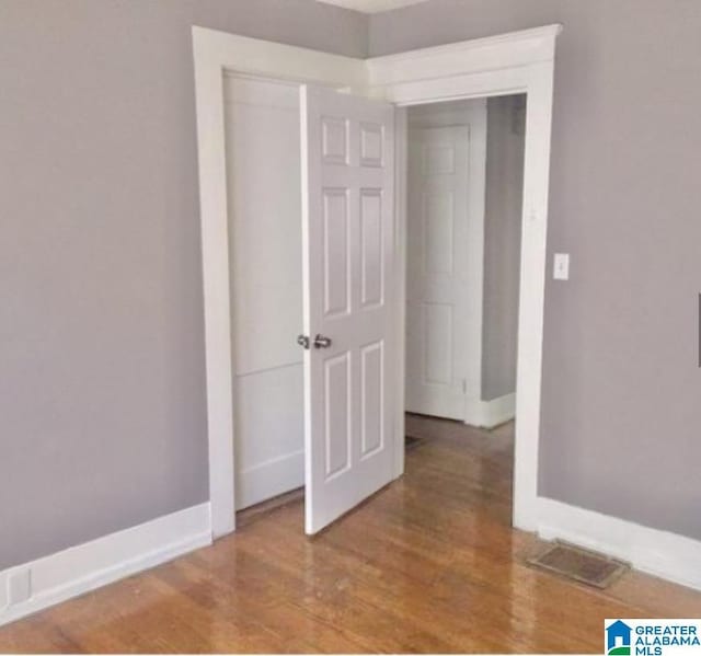 interior space featuring visible vents, baseboards, and wood finished floors