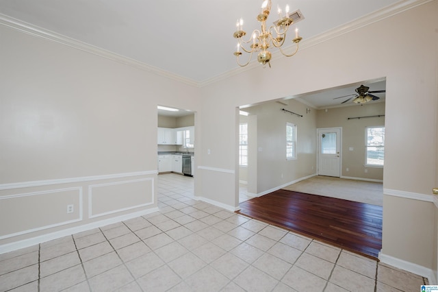 unfurnished room with visible vents, ceiling fan with notable chandelier, light tile patterned flooring, crown molding, and baseboards