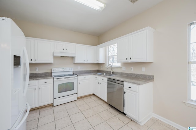 kitchen with white appliances, light tile patterned flooring, a sink, white cabinets, and under cabinet range hood