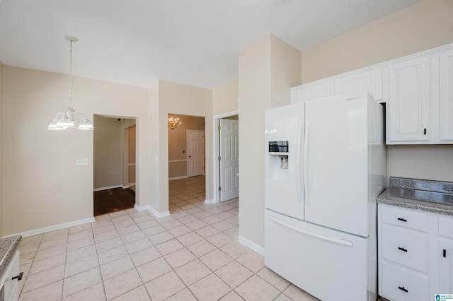 kitchen with white cabinetry, an inviting chandelier, and white refrigerator with ice dispenser