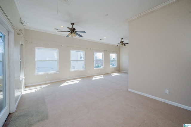 spare room with visible vents, ornamental molding, carpet floors, baseboards, and attic access