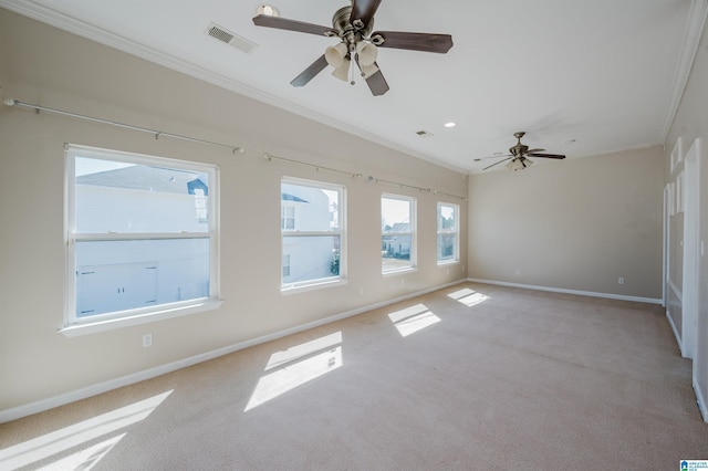 spare room with light colored carpet, baseboards, visible vents, and ornamental molding