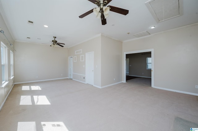 unfurnished room featuring visible vents, light carpet, attic access, and crown molding