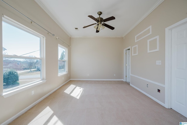 empty room featuring baseboards, light carpet, and ornamental molding