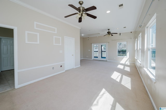 unfurnished living room featuring baseboards, visible vents, ornamental molding, french doors, and light carpet