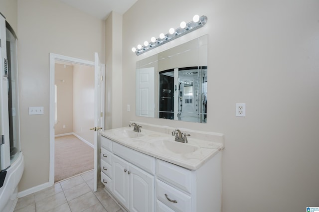 full bathroom with tile patterned floors, double vanity, baseboards, and a sink