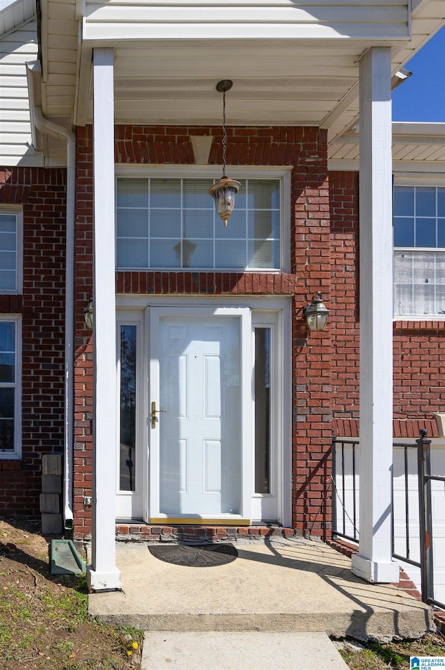 property entrance featuring brick siding