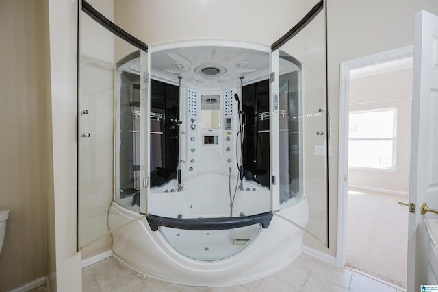 bathroom with tile patterned floors and baseboards