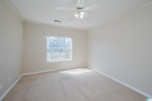 carpeted empty room featuring crown molding, baseboards, visible vents, and ceiling fan